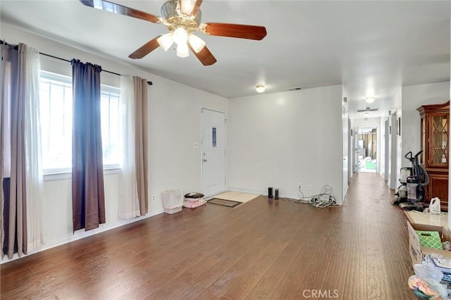 unfurnished room with wood-type flooring and ceiling fan