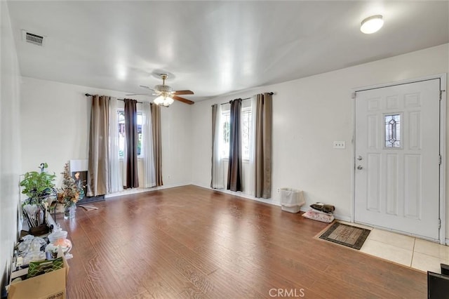 foyer with ceiling fan and wood-type flooring