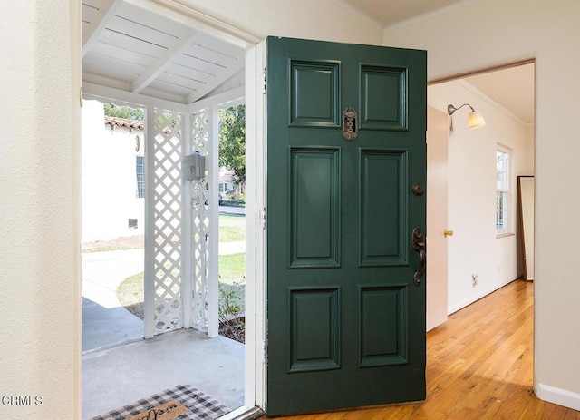 foyer featuring lofted ceiling and light hardwood / wood-style floors