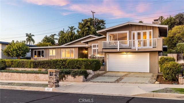 split level home with a garage and a balcony