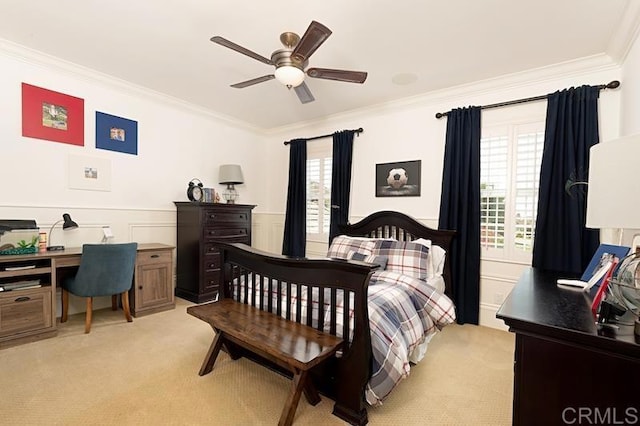 bedroom featuring a wainscoted wall, ornamental molding, and light colored carpet