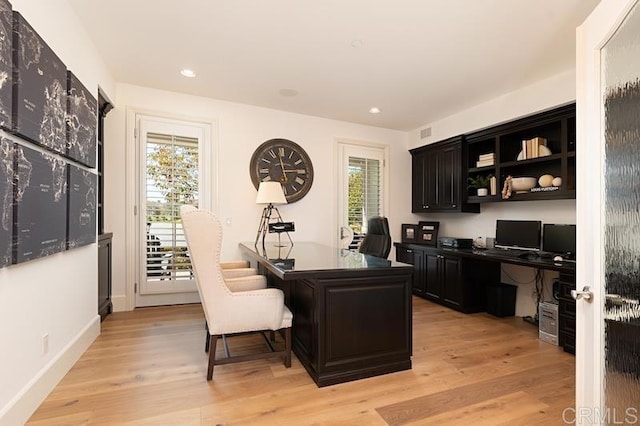 office featuring baseboards, light wood-type flooring, visible vents, and recessed lighting