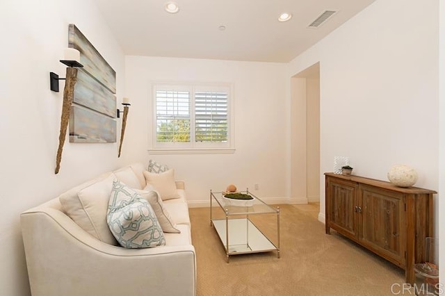 sitting room with baseboards, visible vents, light colored carpet, and recessed lighting