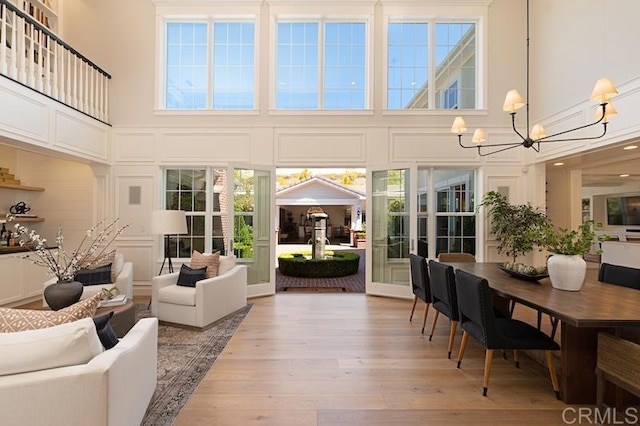 sunroom / solarium featuring a chandelier