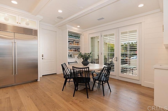 dining space with light wood-style floors, recessed lighting, visible vents, and beamed ceiling