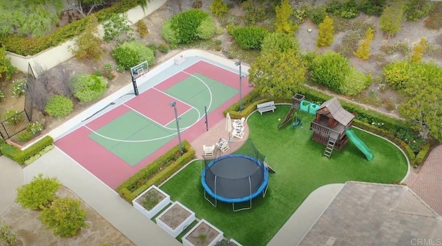 view of sport court featuring community basketball court, a trampoline, and playground community