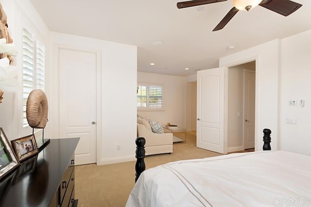 bedroom featuring recessed lighting, light colored carpet, ceiling fan, and baseboards