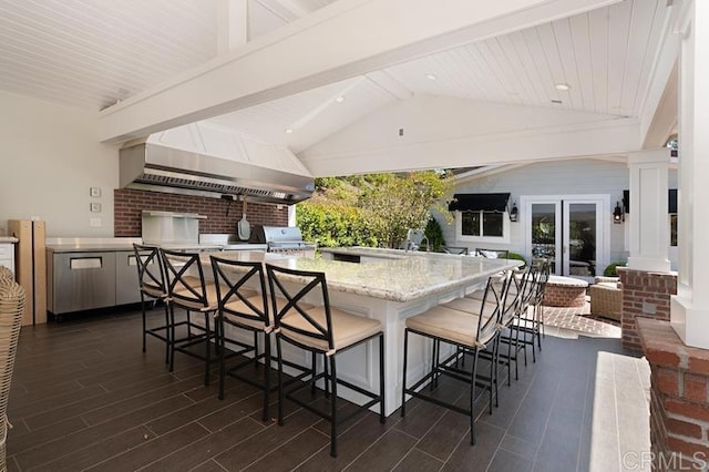 view of patio with outdoor wet bar, a grill, and area for grilling