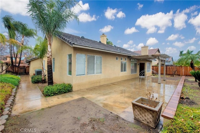 back of property featuring central AC, a pergola, and a patio