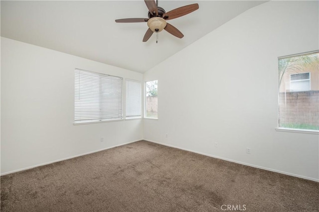 carpeted spare room featuring lofted ceiling and ceiling fan