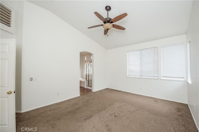 carpeted spare room with ceiling fan and lofted ceiling