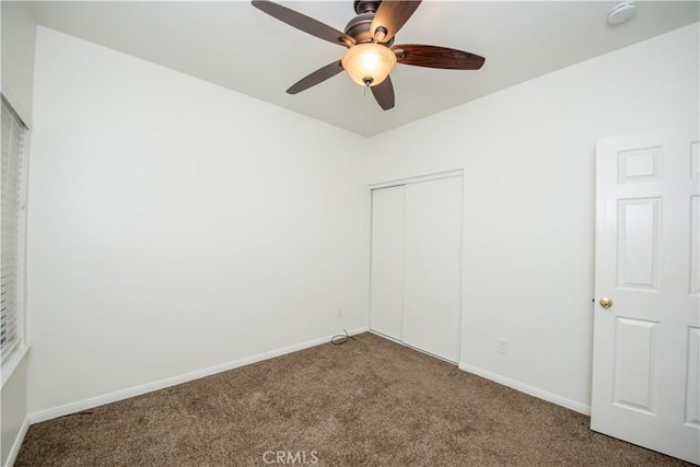 unfurnished bedroom with ceiling fan, carpet floors, and a closet