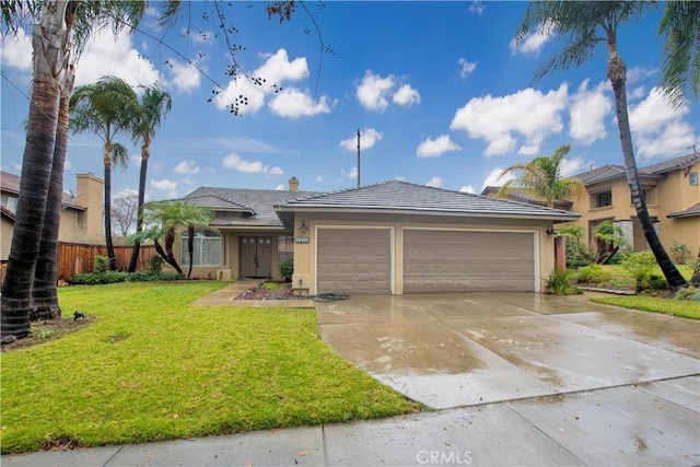 ranch-style house with a garage and a front lawn