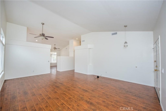 unfurnished living room featuring dark hardwood / wood-style flooring, vaulted ceiling, and ceiling fan