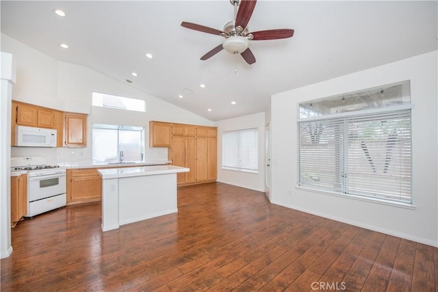 kitchen featuring sink, white appliances, dark hardwood / wood-style floors, and a kitchen island