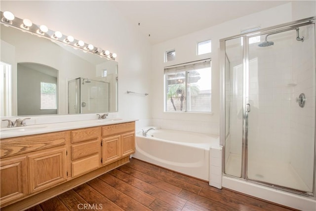 bathroom featuring vanity, a wealth of natural light, wood-type flooring, and independent shower and bath