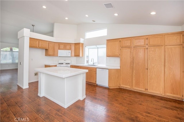 kitchen with sink, white appliances, dark wood-type flooring, and a kitchen island