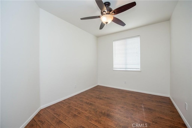 spare room featuring dark wood-type flooring and ceiling fan