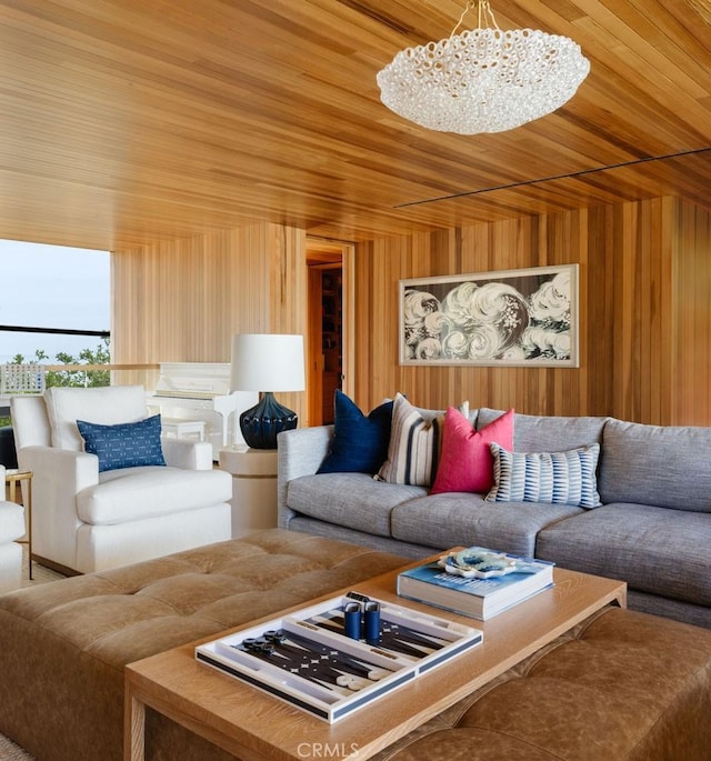 living room featuring wood ceiling, a chandelier, and wood walls