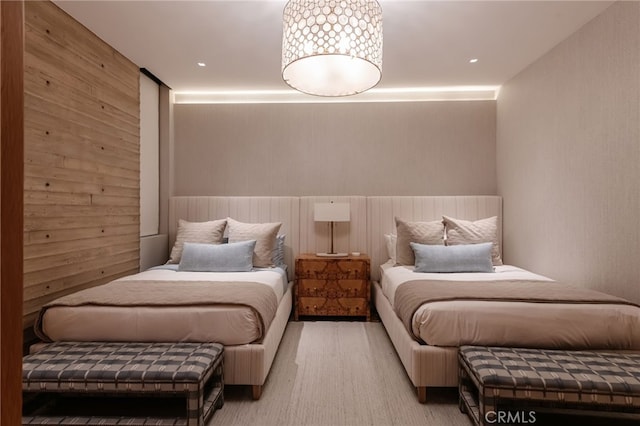 bedroom featuring wooden walls