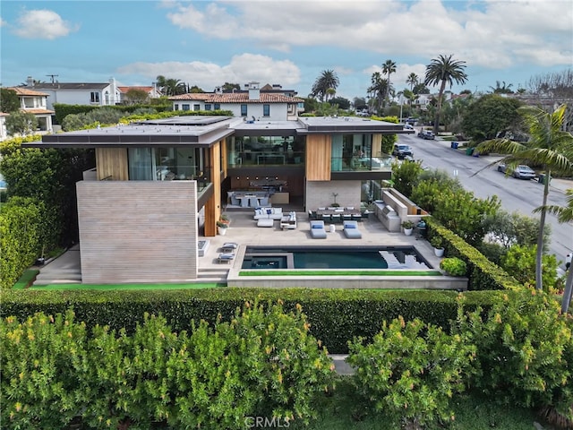 rear view of house with an outdoor hangout area and a patio