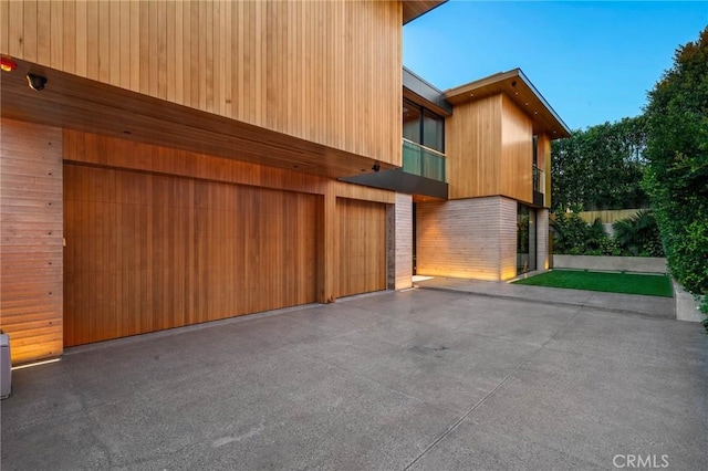 exterior space with a balcony and a garage