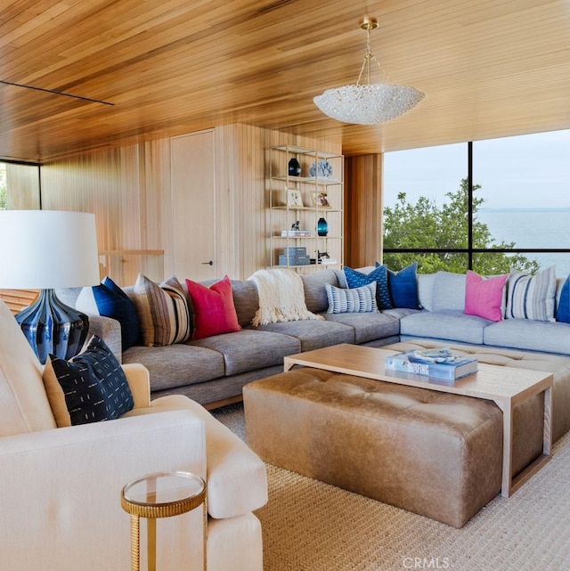 living room with wood ceiling, a chandelier, and wood walls