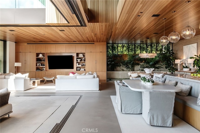 living room featuring wood ceiling, built in features, wooden walls, and concrete floors