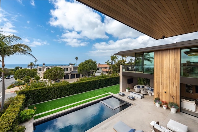 view of swimming pool featuring a patio area, an outdoor hangout area, and a lawn