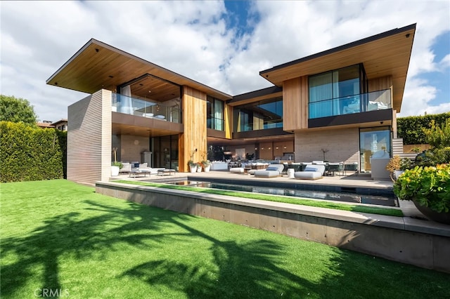 back of house featuring a patio and a lawn