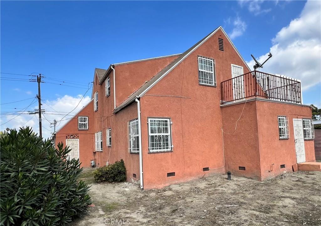 view of side of property with a balcony