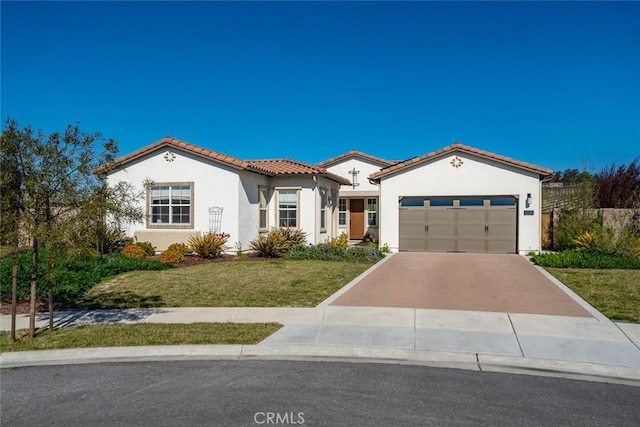 mediterranean / spanish-style house with a garage and a front yard