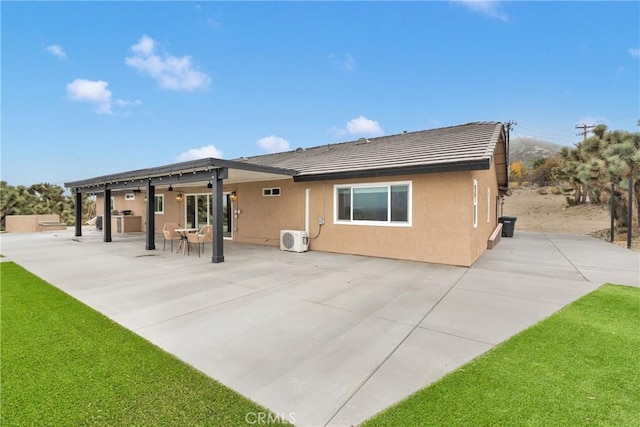 back of house with a patio, a yard, and ac unit