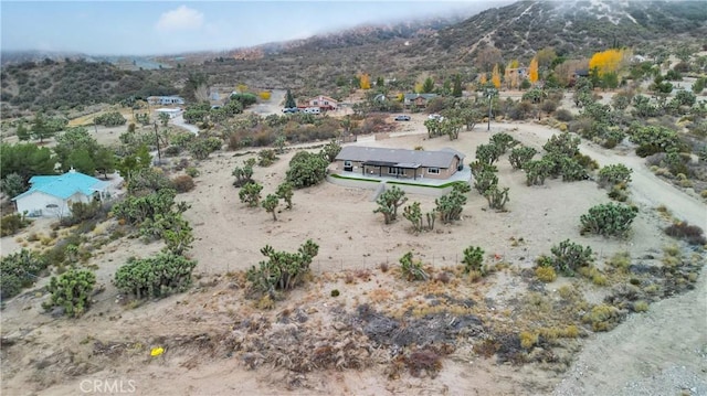 birds eye view of property with a mountain view