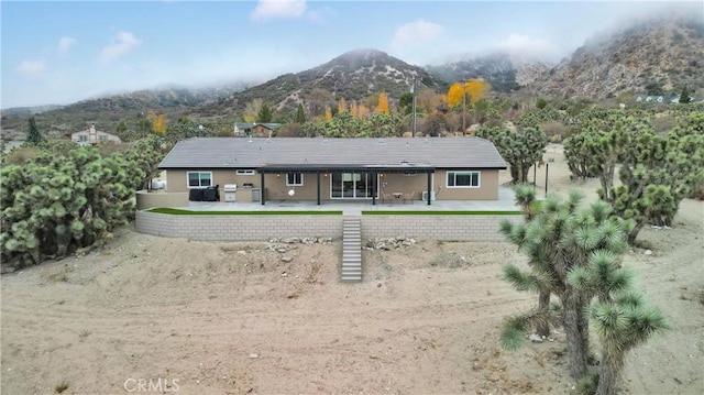 back of house with a patio and a mountain view