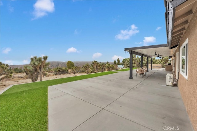 view of patio featuring ceiling fan and ac unit