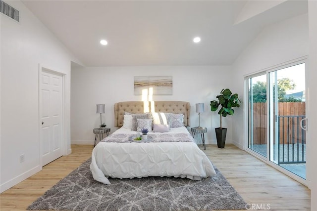 bedroom with lofted ceiling, access to outside, and light hardwood / wood-style floors