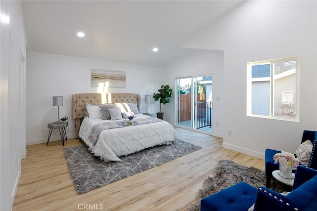 bedroom featuring high vaulted ceiling, light wood-type flooring, and access to outside