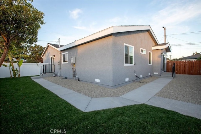 view of side of property with a lawn