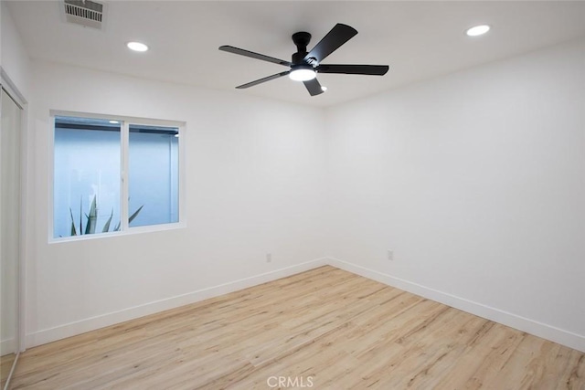 spare room with light hardwood / wood-style flooring and ceiling fan