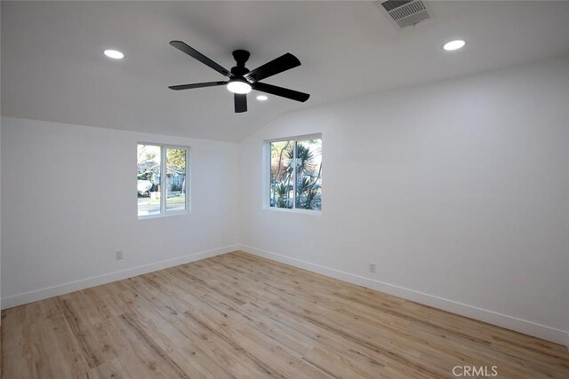 unfurnished room with lofted ceiling, light hardwood / wood-style flooring, and ceiling fan