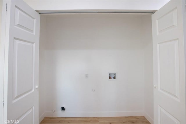 laundry room with gas dryer hookup, washer hookup, and light hardwood / wood-style floors