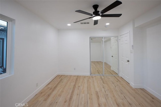 unfurnished bedroom featuring a closet, ceiling fan, and light wood-type flooring