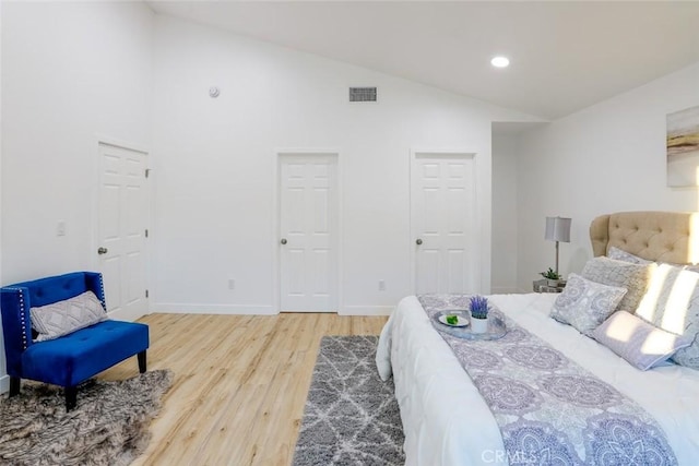 bedroom with hardwood / wood-style flooring and vaulted ceiling