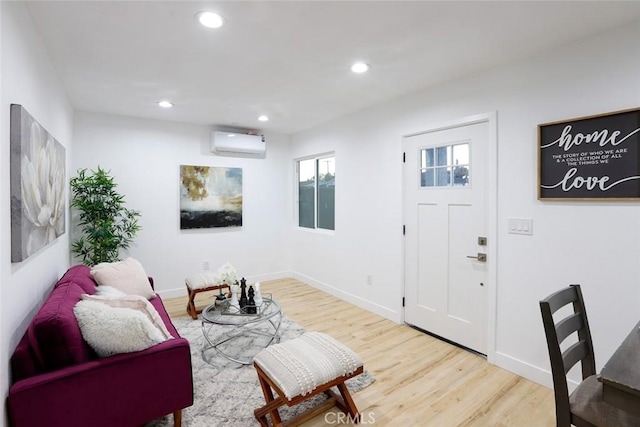 living room with hardwood / wood-style floors and a wall unit AC