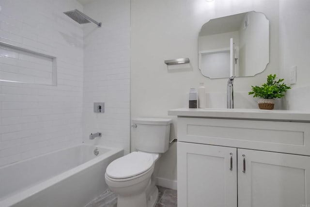 full bathroom with vanity, tiled shower / bath, and toilet