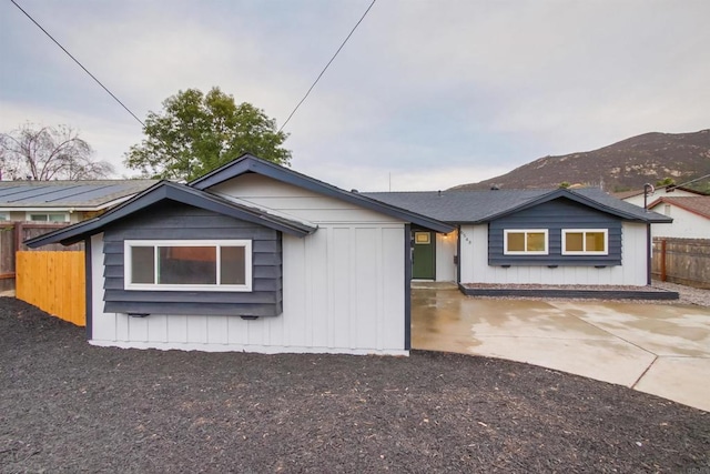 view of front of property with a mountain view and a patio area