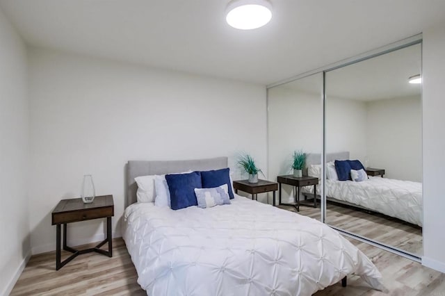 bedroom featuring light hardwood / wood-style floors and a closet