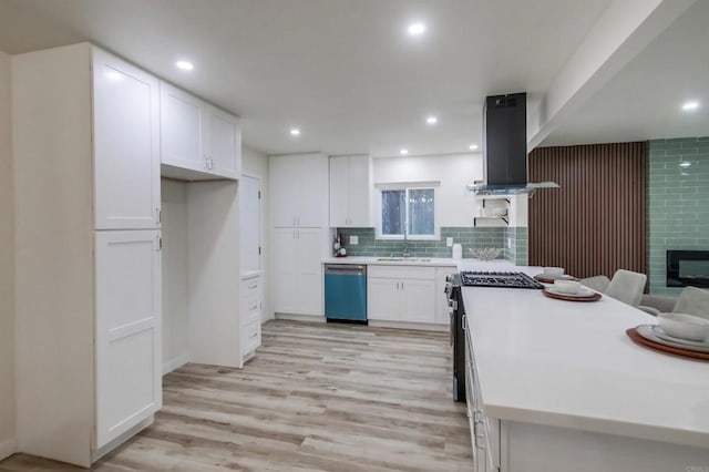 kitchen with sink, appliances with stainless steel finishes, island exhaust hood, light hardwood / wood-style floors, and white cabinets