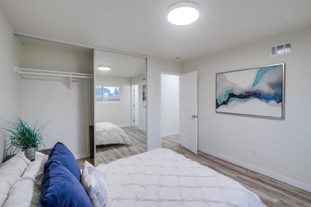 bedroom featuring hardwood / wood-style floors and a closet